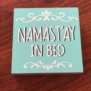Namast’ay in bed sign